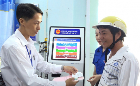 Cán bộ xã Giồng Riềng hướng dẫn người dân sử dụng các tiện ích số, góp phần lan tỏa Phong trào “Bình dân học vụ số”. Ảnh: Bích Thùy