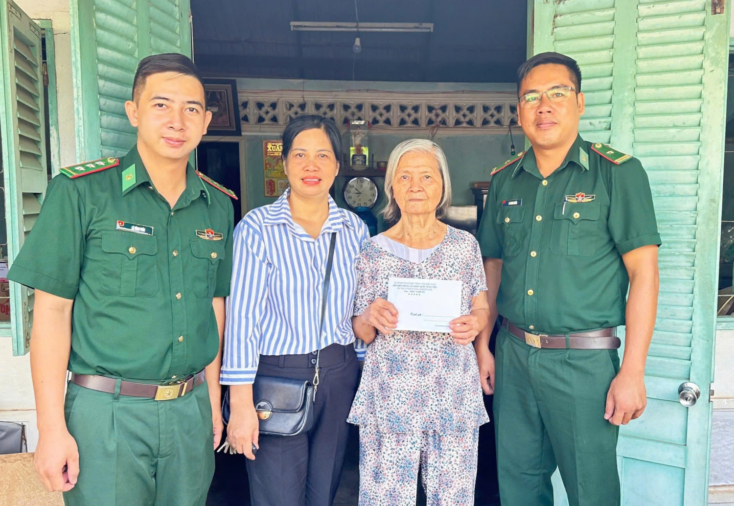 Thiếu tá La Minh Nhòa (ngoài cùng bên phải), tặng quà người cao tuổi có hoàn cảnh khó khăn trên địa bàn phường Hà Tiên.